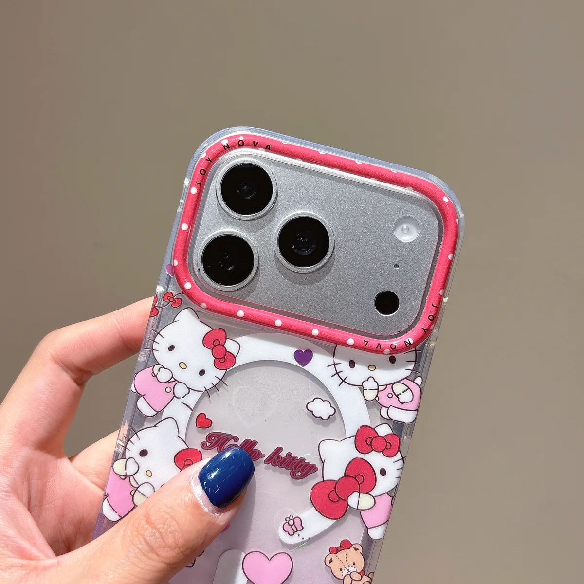 Clear iPhone case with Hello Kitty prints, pink polka-dot camera frame, and cute Sanrio graphics